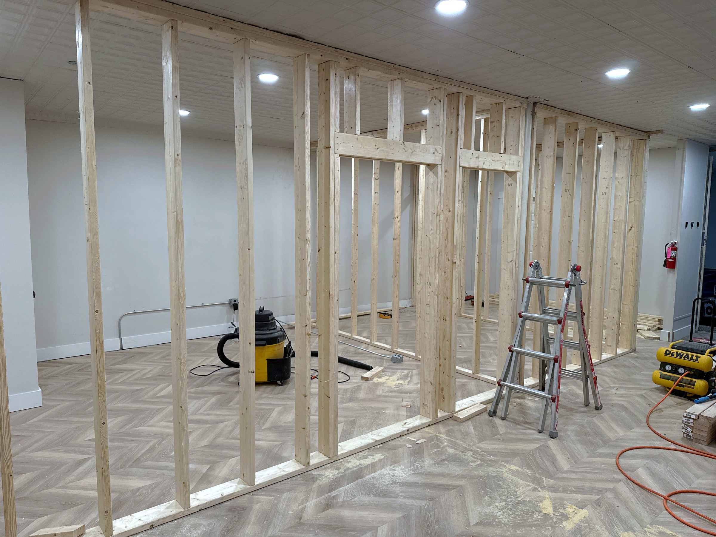 Wood stud wall framing in progress in a basement